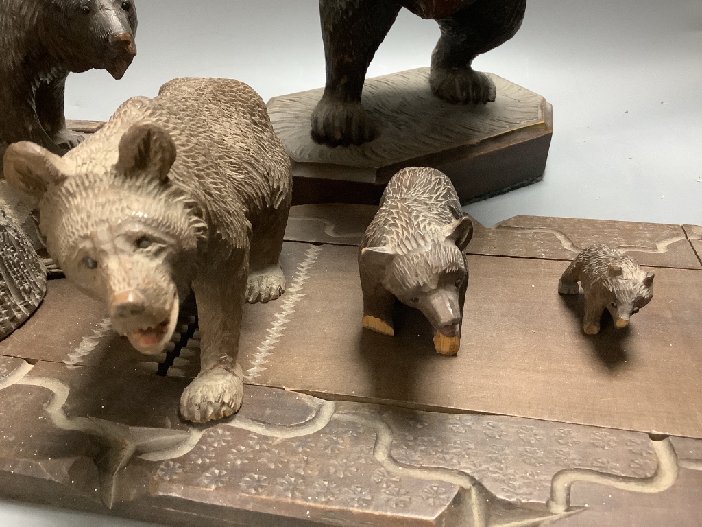 A collection of Black Forest carvings - a bookslide, an ashtray and four bears